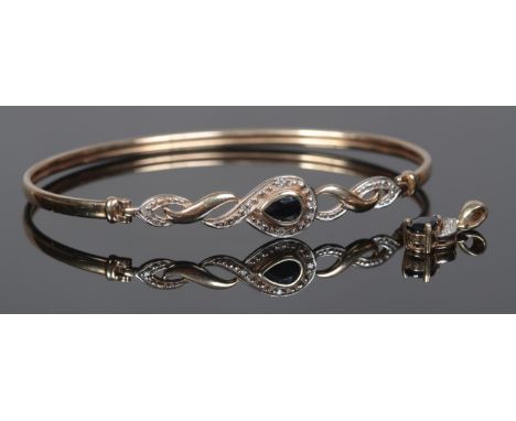 A 9ct Gold hinged bangle, with central sapphire surrounded by small diamonds and beaded surround, together with a yellow meta