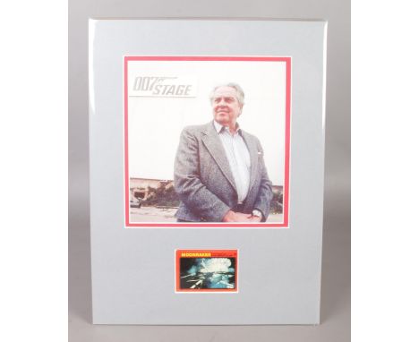 A mounted image of Cubby R. Broccoli, the executive producer of early James Bond films, with lower signed Moonraker card. Hei