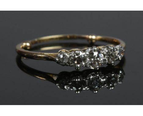 A yellow metal five stone diamond ring. Size O. 2.12g.  Shank with sizing beads.