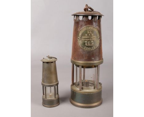 An Eccles Type SL miners safety lamp, together with a miniature example.  Slight rust to Eccles example.