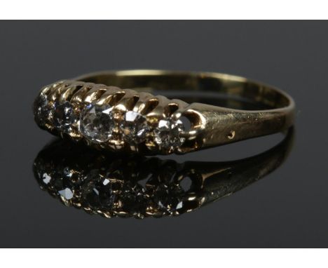 An 18ct gold five stone diamond ring. Size O. 2.88g.  