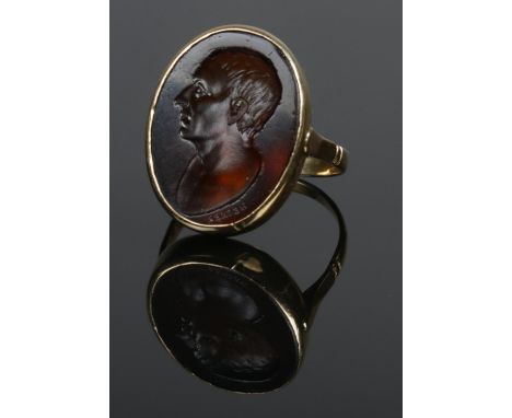 An 18ct gold intaglio ring, portrait of a gent, signed Hecker. Size T. 6.56g. Size of panel 2.3cm x 1.8cm.  Tests as 18ct. Ve
