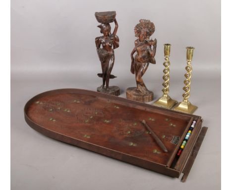 A Bagatelle, a pair of brass candlesticks and pair of carved Bali figures.  Bagatelle comes with balls, but spring needs atte