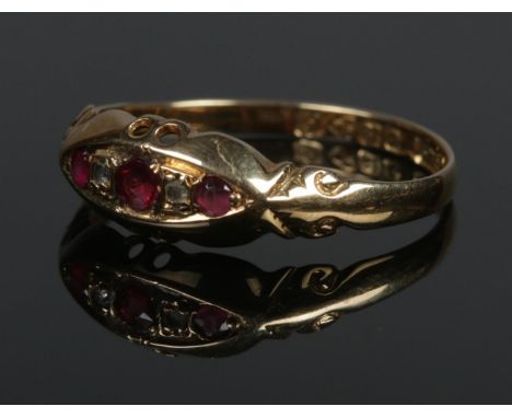 An 18ct gold diamond and pink stone ring in boat shaped setting. Size P 1/2. 1.67g.  