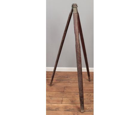 An antique wood and brass tripod theodolite stand.  