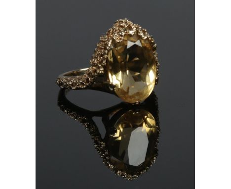 A vintage 9ct gold ring set with a large citrine stone. Assayed London 1972. Size K. 5.22g.  