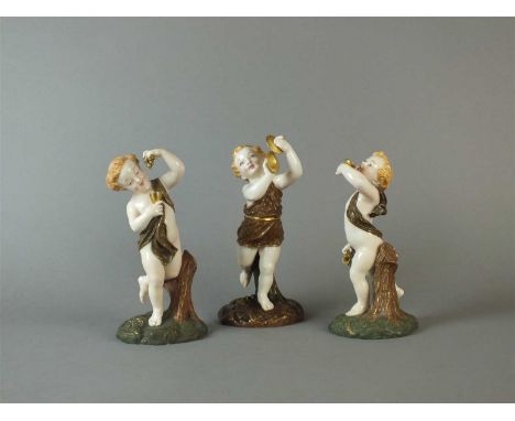 Three Royal Worcester porcelain figures, late 19th century modelled as young boys playing a tamborine, drinking, and making m