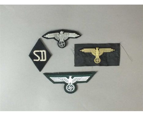 German Third Reich cloth insignia comprising a Heer NCO/Officer's flatwire breast eagle, silver against dark green backing to