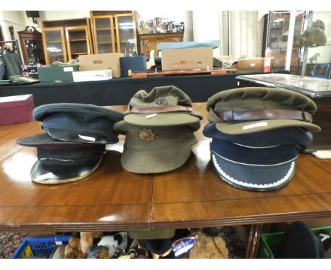 A large collection of post-war military visor caps - including British Army and West German (qty)