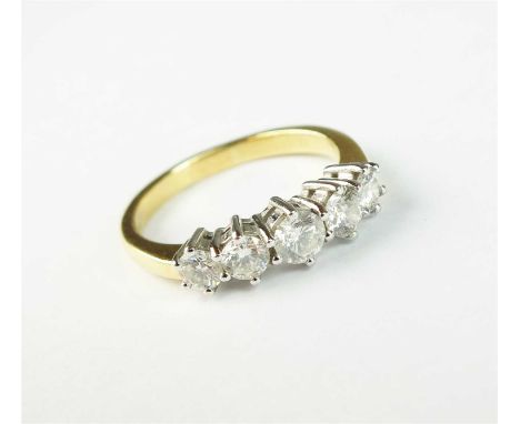 An 18ct gold five stone diamond ring, the graduated brilliant cut diamonds claw set in white gold to yellow gold shank, ring 