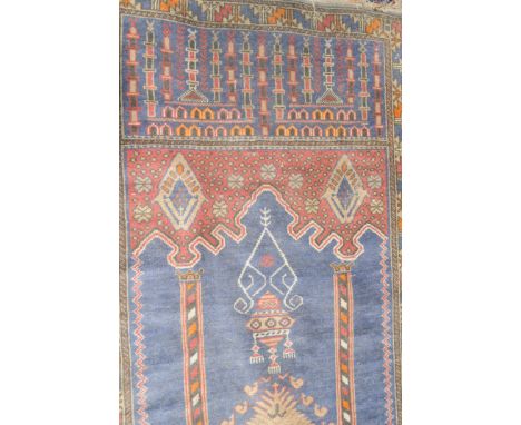 A Baluch Rug, West Afghanistan, The Indigo field with lamp, beneath the Mihrab, enclosed by leaf and calyx borders 135cm x 85