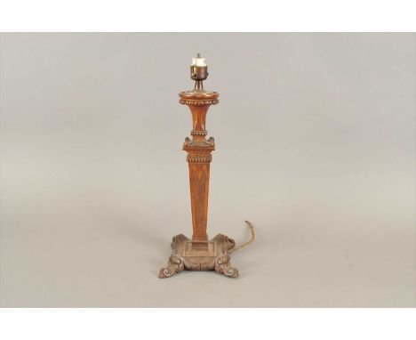A carved oak table lamp, loosely in the Adam style, with a shallow carved squared tapering stem over a scrolling acanthus car