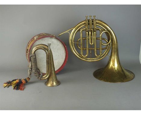A military brass bugle with coloured bugle cords together with a painted sidedrum and a brass French horn lacking mouthpiece,