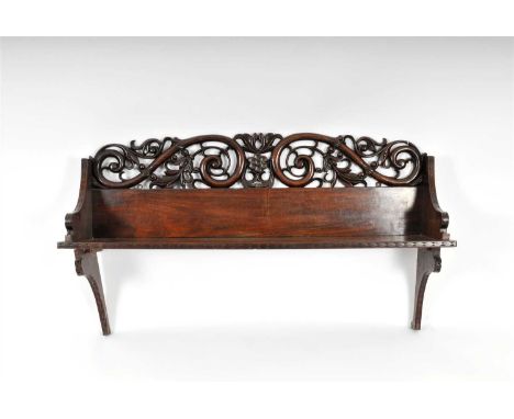 A Regency Anglo-Indian carved rosewood wall shelf, with an intricately carved and pierced symmetrical back decorated with sty