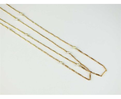 An early 20th century pearl set guard chain, the yellow metal elongated link chain interspersed with fourteen single untested