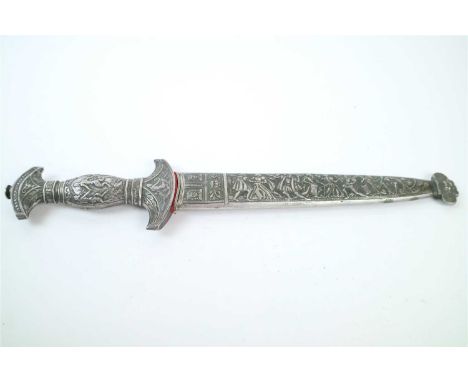 A decorative reproduction dagger affixed to a heavily relief decorated white metal scabbard with figural decoration in mediev