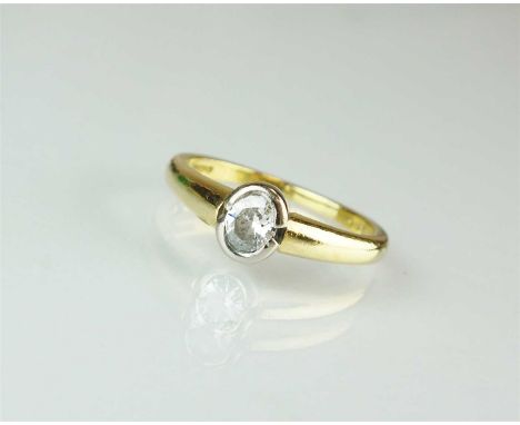An 18ct gold single stone diamond ring, the oval brilliant cut diamond collet set in white gold to yellow gold shank, ring si