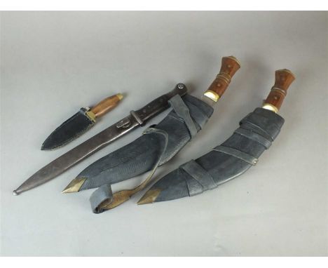 A German WW2 K98 Mauser bayonet and scabbard together with two kukri knives in leather sheaves and a modern miniature dagger 