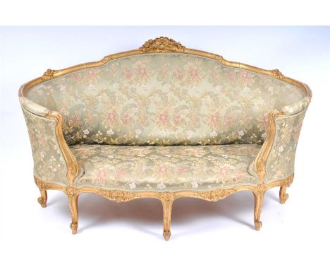 A 19th century French carved gilt wood framed upholstered parlour sofa, the shaped back surmounted with a highly detailed arc
