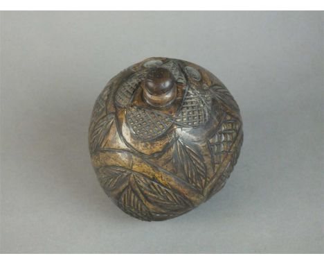 A 'Bugbear' carved powder flask coconut, 19th century, with original stopper, 12cm high