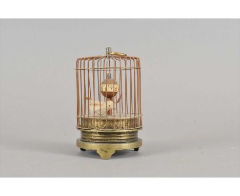 A miniature lacquered brass automaton / timer, in the form of a songbird in a cage, 11 cm high.