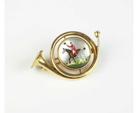 An Essex crystal hunting scene brooch, the circular Essex crystal cabochon depicts a huntsman on horseback and two beagles, m