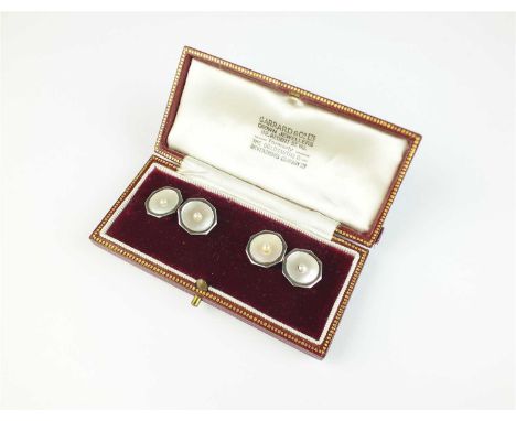 A pair of mother of pearl and seed pearl cufflinks, the yellow metal reverse stamped '18', presented within Garrard &amp; Co 