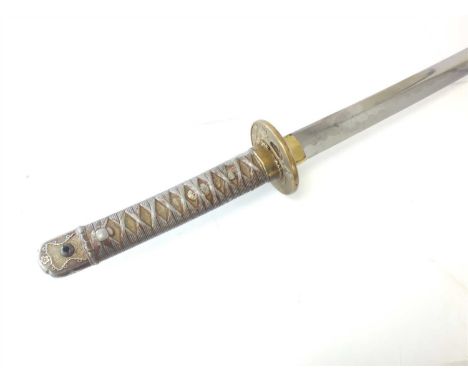 A World War Two Japanese katana sword with active hamon to the 71cm length blade, the brass tsuba decorated with military fig