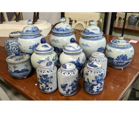 JARS WITH COVERS, a set of twelve of various descriptions, Chinese export style blue and white ceramic, 24cm H at tallest. (1