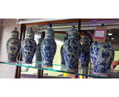 VASES WITH COVERS, a set of four and one other, Chinese export style blue and white ceramic, 36cm H at largest. (5) 
