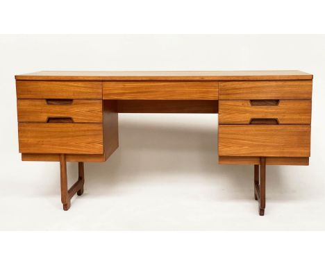 UNIFLEX DESK, 153cm W x 45cm D x 75cm H, 1970s teak, with seven drawers and contrast wood recess handles and supports. 