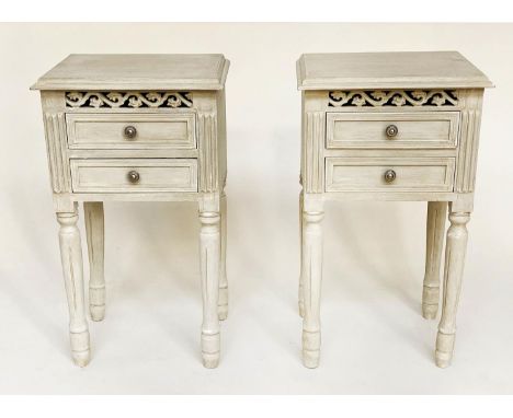 BEDSIDE CHESTS, a pair French grey painted each with two drawers and pierced frieze, 40cm W x 70cm H x 32cm D. 
