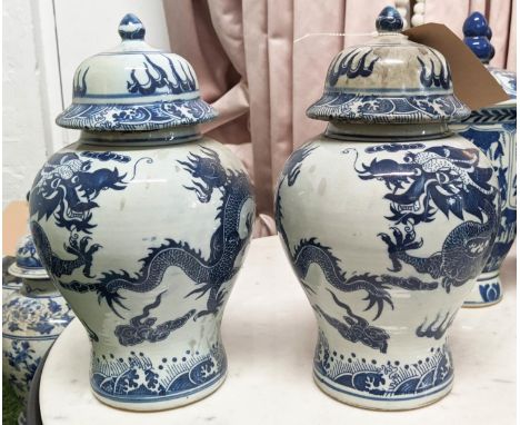 BALUSTER VASES WITH COVERS, a set of three, Chinese export style blue and white ceramic, dragon decoration, 31cm H. (3) 