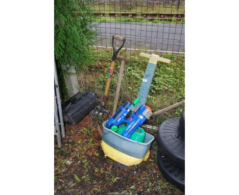 A garden sprayer, garden tools and a water gun.