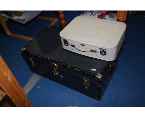 Black trunk plus a small suitcase.