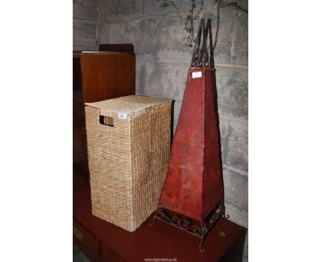 A wicker hamper/laundry bin and a pyramid shade.