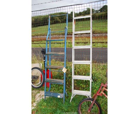 Two step ladders; one six rung aluminum, one steel.