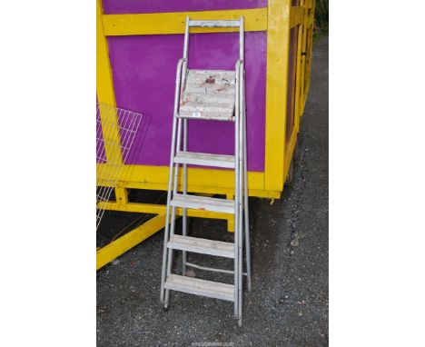 A five rung aluminum step ladder.