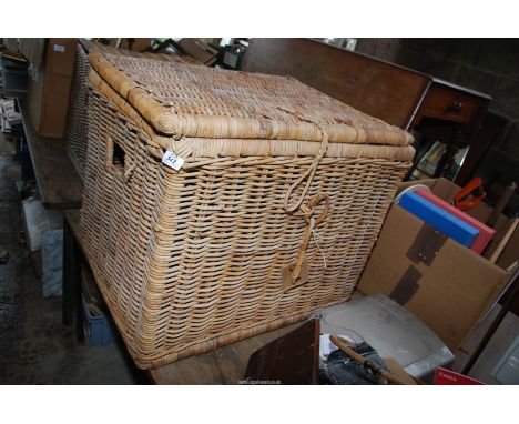 A wicker trunk, 22'' x 27 1/2'' x 23'' high.