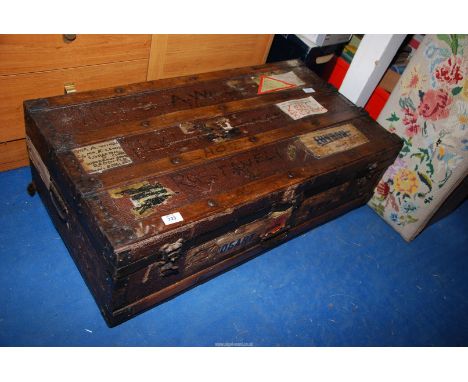 A wooden trunk with labels - 19" x 3' x 12" high.