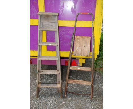 A metal three rung step ladder and a six rung wooden step ladder.