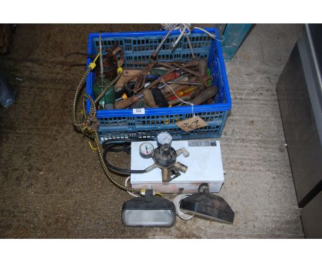 Spot lamps, gas regulator, tools and oil cans.