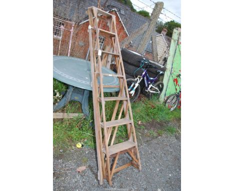 A Seven rung wooden step ladder.
