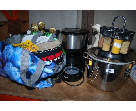 A spice rack and a pressure pot, books, weight belt etc.