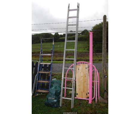 An 11 rung extending aluminum ladder.