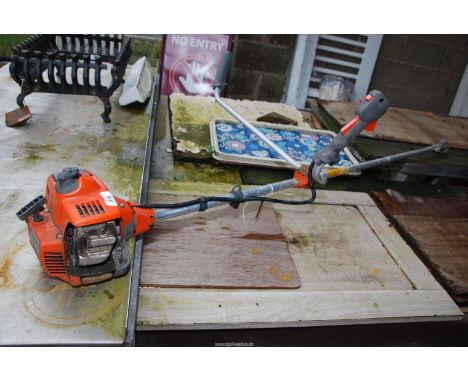 A Husqvarna strimmer with no head, engine turns.