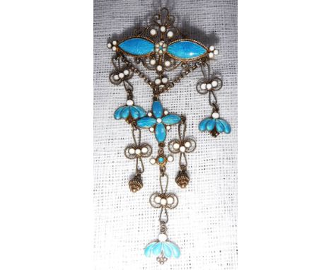 A SILVER FILIGREE AND ENAMEL BROOCH