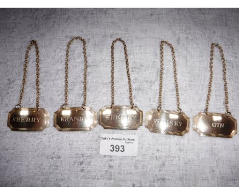 A COLLECTION OF FIVE SILVER BOTTLE LABELS including 'Gin' and 'Sherry'