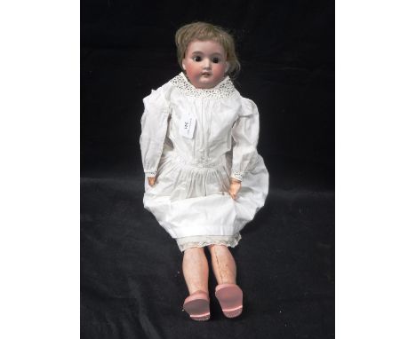 A CERAMIC HEADED DOLL with composition arms and legs