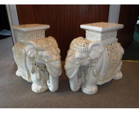 A PAIR OF ORIENTAL CREAM CERAMIC GLAZED GARDEN SEATS in the form of elephants